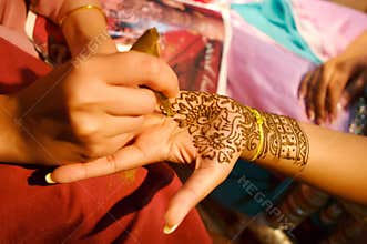 Indian wedding bride getting henna applied