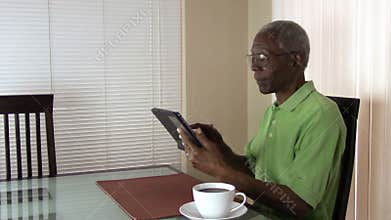 Senior citizen working with a tablet at home in Arizona.