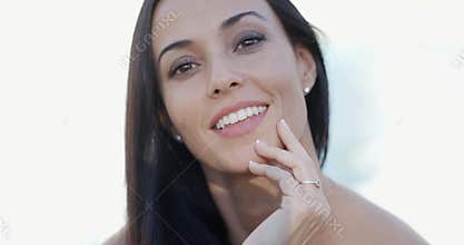 Happy vivacious woman enjoying summer sunshine