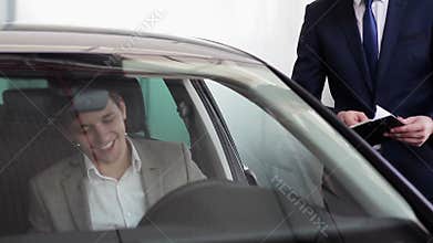 Young businessman received the keys to a new car