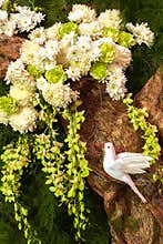 White Dove on Paper Tree with White Flowers, Orchid and Leaves for Decoration