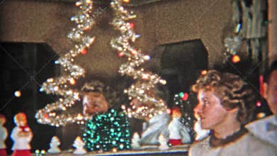 DETROIT, MICHIGAN 1953: Mom and daughter in front of great Christmas tree.