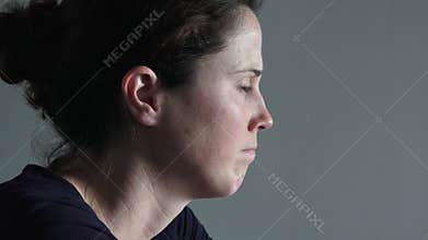Caucasian woman in her thirties (30s) sitting at a table upset looking at the camera