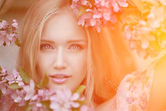 Young spring fashion woman in spring garden. Springtime. Trendy