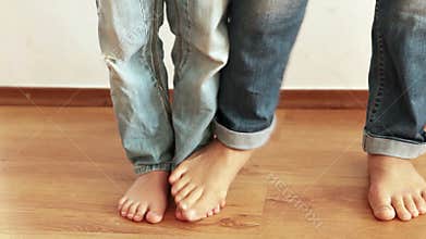 A funny footage of mother and son stepping on each other's feet