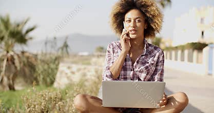 Young African Woman Working On Laptop In Nature.