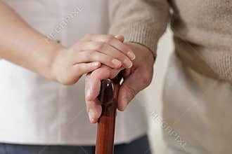 Carer holding old man hand