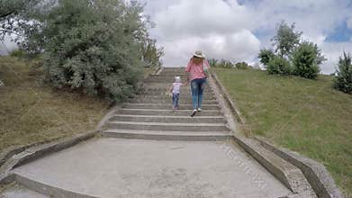 Mother and her daughter climbing stairs video