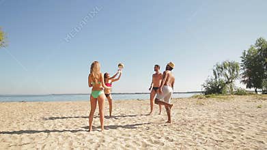 Vacationers playing volleyball on the beach.