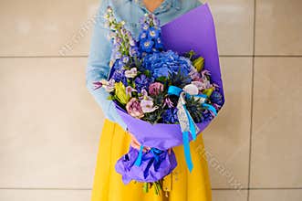 Girl holding purple and pink flower bouquet