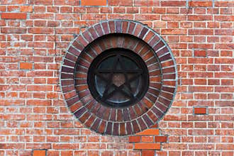 Star sign on red brick wal
