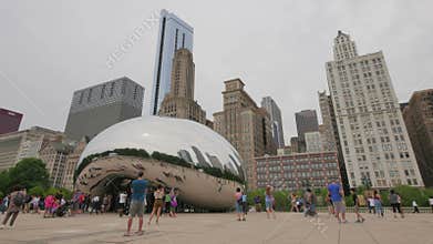 Tourists at the Chicago Bean Monument in Millennium Park.