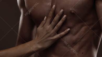 Athletic torso and woman hand