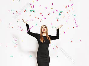 Young woman celebrating, confetti falling