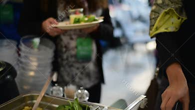 Picking food from buffet at the conference