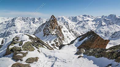 Beautiful Sunny Winter Day in Snowy Alps Mountains.Time Lapse Dolly Shot over Snowy Rocks and Majestic Peaks