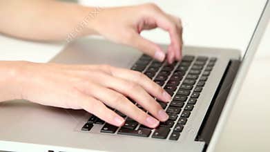 Beautiful young blond telesales woman with headphones on computer talking to customer over the phone