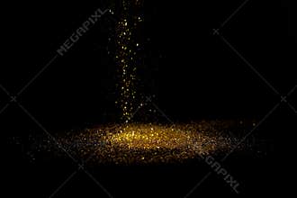 Sprinkle gold dust on a black background