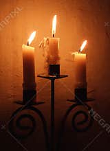 Three candles burning in a 13th century English parish Church