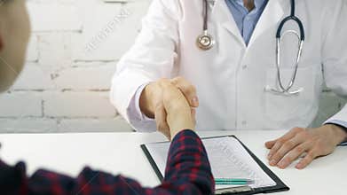 Patient and physician handshake after medical consultation