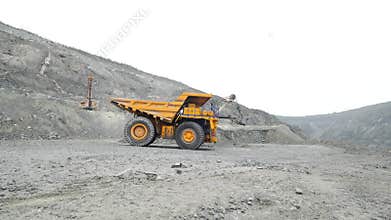 Heavy mining trucks moving on a limestone quarry. Heavy equipment.