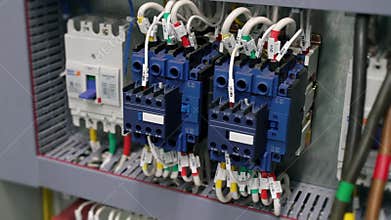 Electrical box contains many terminals, relays, wires and switches. Manufacture and installation concept concept.