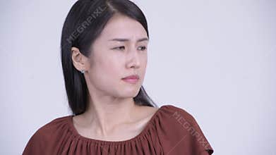 Face of stressed Asian woman looking disgusted