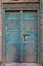 Ancient door carved with engravings of an ancient mud house in Oman 2