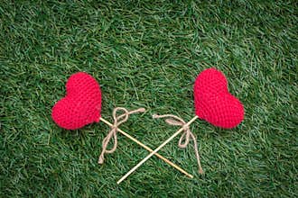 Love heart cross on green grass with space for text