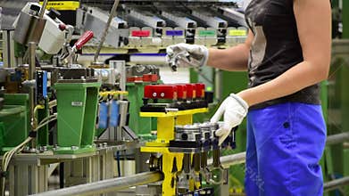 Female worker assemble a car engine