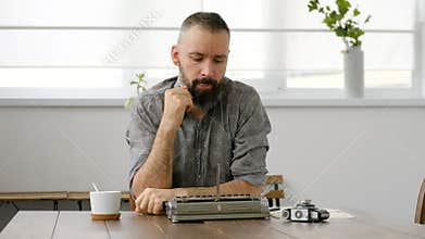 Male writer looking for inspiration and typiing