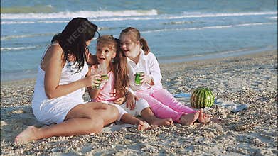Happy family. Mother, youngest daughter and an seventeen-year-old daughter with Down syndrome.
