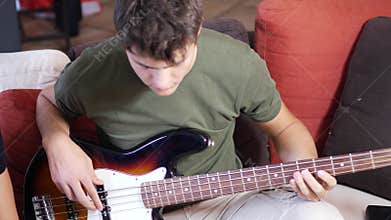 Young men playing electric guitars