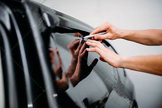 Specialist work with car, tinting film installing