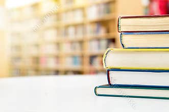 Stack and pile of books on tableublic or school library. in p