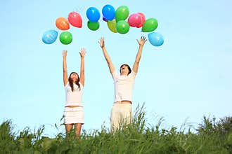Girl and guy start balloons in sky
