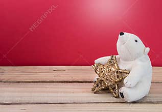 Christmas gold star with fluffy polar bear toy. Christmas holiday celebration concept.