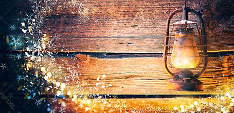 Vintage oil lamp over Christmas wooden background