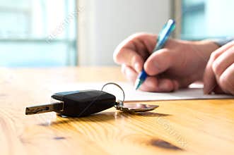 Man signing car insurance document or lease paper.
