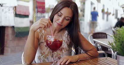 Content woman enjoying drink in cafe