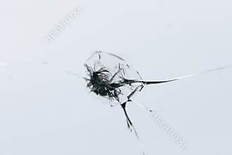 Closeup of cracked windshield with fissure lines, abstract background with copy space