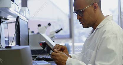 Scientist using digital tablet in laboratory 4k