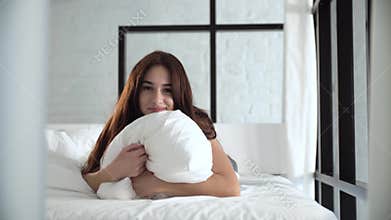 Beautiful Woman Lying On Comfortable Bed And Hugging Pillow