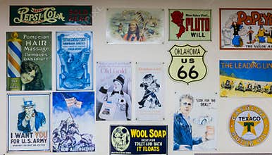 CUBA, MISSOURI - APRIL 5, 2018 - Collection of vintage metal signs and logos of former and actual companies displayed on a wall