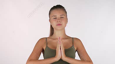 Beautiful young woman meditating with eyes closed isolated
