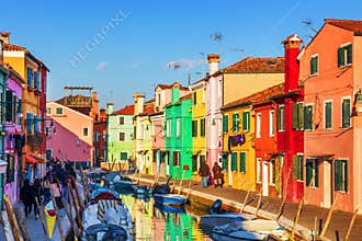 Lovely house facade and colorful walls in Burano, Venice. Burano island canal, colorful houses and boats, Venice landmark, Italy.