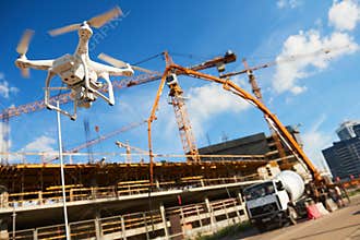 Drone over construction site. video surveillance or industrial inspection