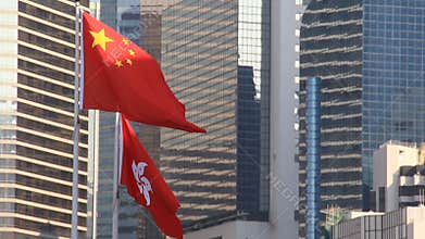 Flags of China and Hong Kong flying in the wind
