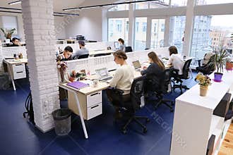 Office space in middle of working day with people immersed in wo