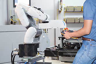Engineer controlling automated robotic for holding assembly